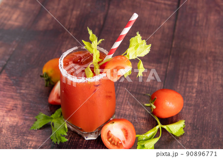 glass glass of tomato juice with fresh bright tomatoes, green parsley on a dark background. vegetable drink. glass glass of tomato juice with fresh bright tomatoes, green parsley on a dark background. vegetable drink. 90896771