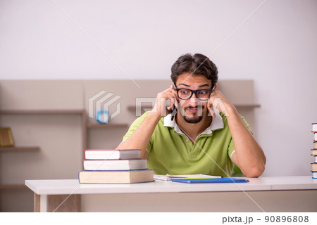 Young male student studying at home Young male student studying at home 90896808