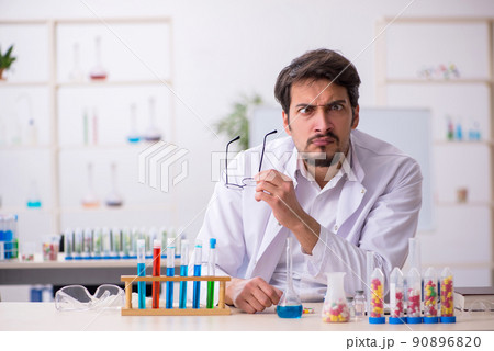 Young male chemist in drugs synthesis concept Young male chemist in drugs synthesis concept 90896820