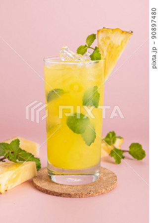 Pineapple cocktail or fresh pineapple juice, mint leaves in glass Pineapple cocktail or fresh pineapple juice, mint leaves in glass 90897480