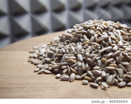 A pile of peeled sunflower seeds on a wooden surface, close-up A pile of peeled sunflower seeds on a wooden surface, close-up 90898604