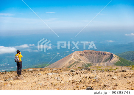 一切経山から望む　吾妻小富士　火口　雲の上　男性　スマホ 90898743