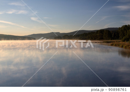Sunrise over the lake in fog, summer morning, Predni Vyton, Lipno lake, Czech republic Sunrise over the lake in fog, summer morning, Predni Vyton, Lipno lake, Czech republic 90898761