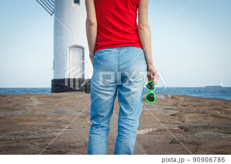 Woman with sunglasses in shape of heart on west breakwater in Swinoujscie 90906786