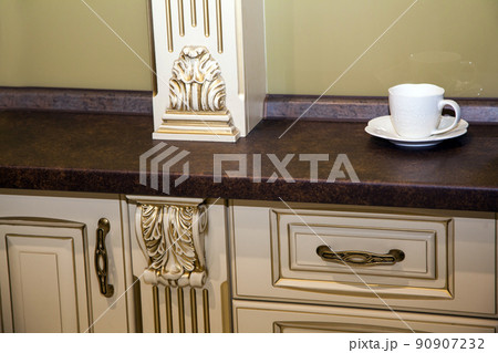 white ceramic cup with saucer on table in kitchen 90907232
