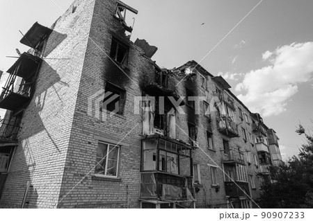 War in Ukraine - destroyed building in Makariv, black and white photo 90907233