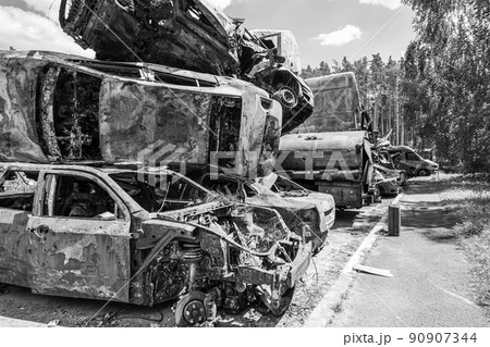 War in Ukraine: a dump of shot and burned cars in Irpin, Bucha district, black and white War in Ukraine: a dump of shot and burned cars in Irpin, Bucha district, black and white 90907344