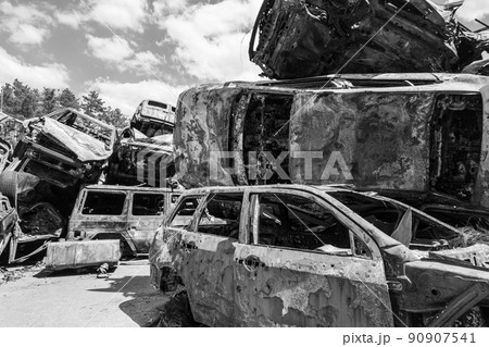 War-destroyed cars in Irpin, Bucha district, Ukraine, black and white War-destroyed cars in Irpin, Bucha district, Ukraine, black and white 90907541