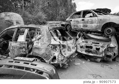 War in Ukraine: a dump of shot and burned cars in Irpin, Bucha district, black and white 90907573