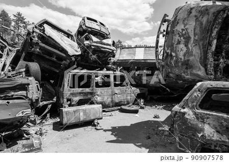 War in Ukraine: a dump of shot and burned cars in Irpin, Bucha district, black and white 90907578