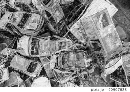 War-destroyed cars in Irpin, Bucha district, Ukraine, black and white 90907628
