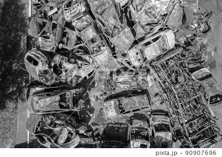 War in Ukraine: a dump of shot and burned cars in Irpin, Bucha district, black and white 90907696