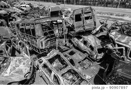 War in Ukraine: a dump of shot and burned cars in Irpin, Bucha district, black and white 90907897