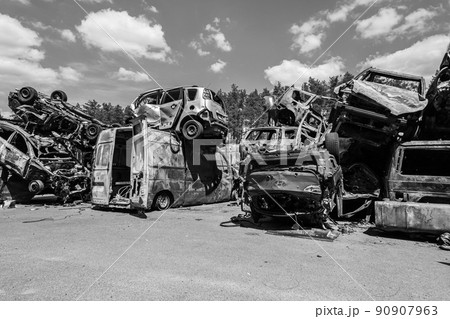 War-destroyed cars in Irpin, Bucha district, Ukraine, black and white 90907963