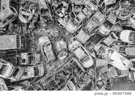 War-destroyed cars in Irpin, Bucha district, Ukraine, black and white 90907986
