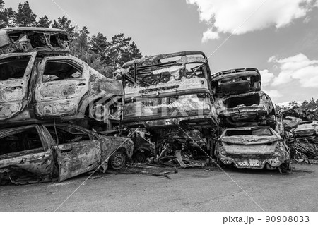 War-destroyed cars in Irpin, Bucha district, Ukraine, black and white 90908033