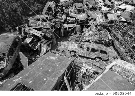 War in Ukraine: a dump of shot and burned cars in Irpin, Bucha district, black and white 90908044