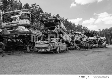 War-destroyed cars in Irpin, Bucha district, Ukraine, black and white 90908085
