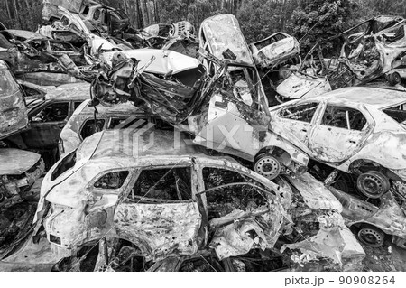 War in Ukraine: a dump of shot and burned cars in Irpin, Bucha district, black and white War in Ukraine: a dump of shot and burned cars in Irpin, Bucha district, black and white 90908264