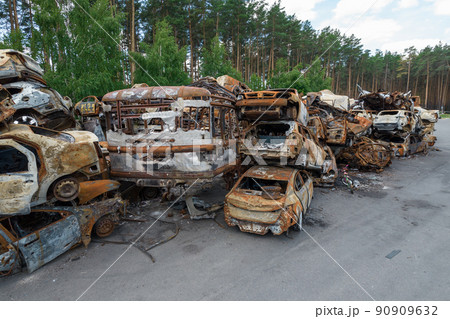 War-destroyed cars in Irpin, Bucha district, Ukraine 90909632