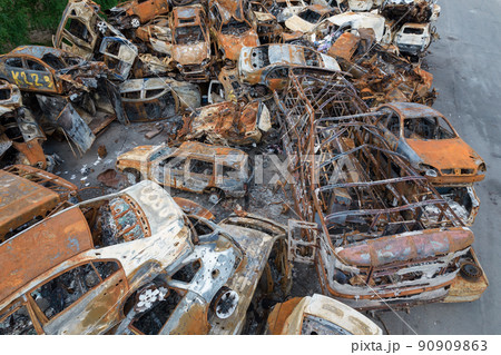 War-destroyed cars in Irpin, Bucha district, Ukraine 90909863