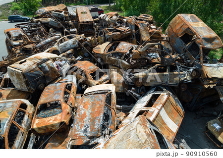 War-destroyed cars in Irpin, Bucha district, Ukraine 90910560