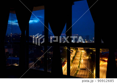 Night view from the window of the apartment on a multi-lane highway in the direction of the metropolis. Night view. 90912685