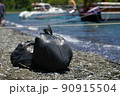 bags of collected garbage from the beach for recycling, cleaning the beach from pollution 90915504