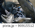 close-up of plastic garbage in a trash bag, drinking straw 90915512