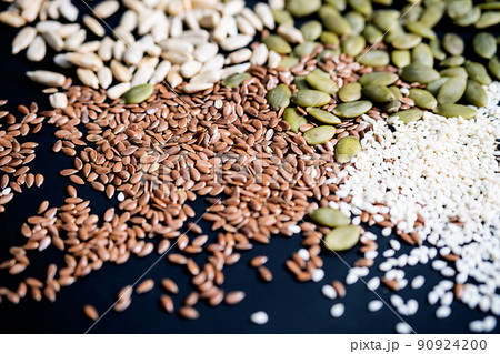 Various seed on the black. Flax, sesame, sunflower and pumpkin seed, close up. Various seed on the black. Flax, sesame, sunflower and pumpkin seed, close up. 90924200