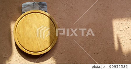 Empty wooden dishes, kitchen utensils on a brown background. Eco-friendly tableware. Top view. Copy space Empty wooden dishes, kitchen utensils on a brown background. Eco-friendly tableware. Top view. Copy space 90932586