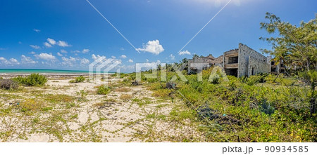 Picture of a destroyed, overgrown and left to itself hotel complex on a beach Picture of a destroyed, overgrown and left to itself hotel complex on a beach 90934585