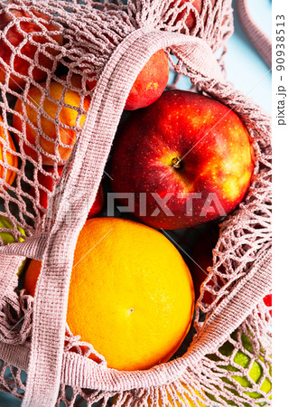 String mesh bag for grocery with various fruits. Reusable shopping tote bag, zero waste concept. String mesh bag for grocery with various fruits. Reusable shopping tote bag, zero waste concept. 90938513