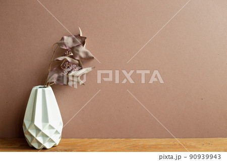 Vase of dry flowers on wooden table. brown wall background. home interior Vase of dry flowers on wooden table. brown wall background. home interior 90939943