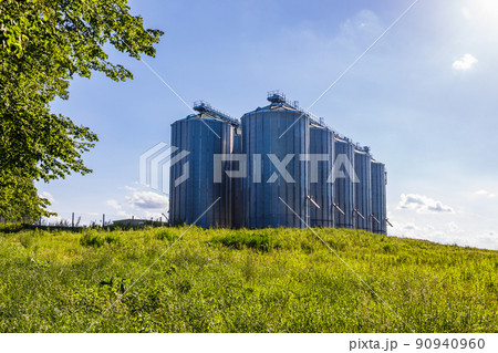 Agricultural silos granary tower. Large iron barrels of grain Agricultural silos granary tower. Large iron barrels of grain 90940960