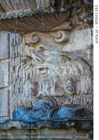 Ancient sculpture of funny, tricky and joyful dickens at fountains in historical downtown of Dresden, Germany, details, closeup. Concept of art and historical heritage. 90941365