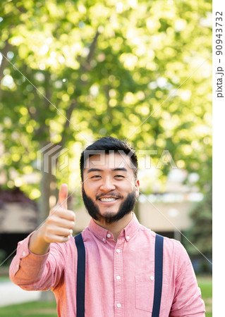 Vertical portrait of an asian man gesturing being well 90943732