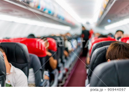 seats in the airplane and passenger sitting all area waiting for the plane taking off from runway. seats in the airplane and passenger sitting all area waiting for the plane taking off from runway. 90944097