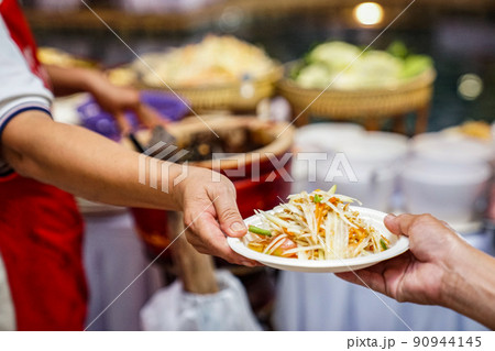 hand to hand somtum (spicy Thai papaya salad) famouse local traditional unique salad in the world. 90944145