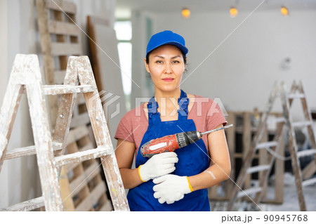 Portrait of asian woman builder with drill Portrait of asian woman builder with drill 90945768
