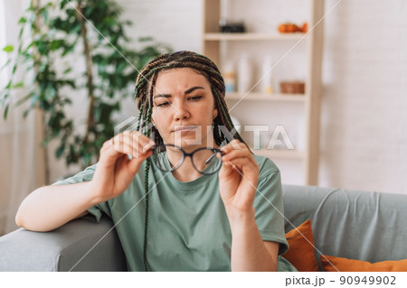The girl looks at the glasses checking for dirt The girl looks at the glasses checking for dirt 90949902