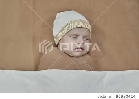 Newborn baby girl, sleeping on a blanket. 90950414
