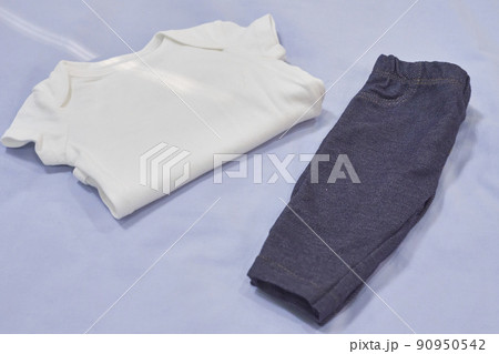 Mockup of white baby bodysuit shirt and jeans on blue background Mockup of white baby bodysuit shirt and jeans on blue background 90950542