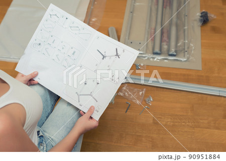 Instruction for furniture assembling in the female hands for self assembly. 90951884