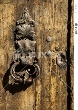 Antique knob on old wooden door 90952330