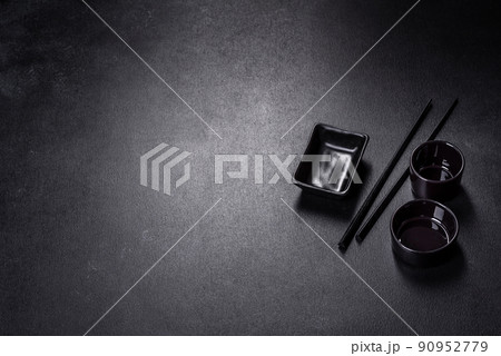 Wooden sushi sticks on a dark concrete background 90952779