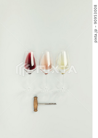 Flat-lay of red, rose and white wine in glasses on white background 90953008