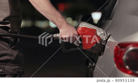Fuel station nozzle filling car tank 90953139