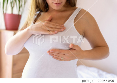 Breast exam cancer pregnancy woman check. Happy young pregnant woman self exam. Breast self exam. Health, medicine and beauty concept. 90954056