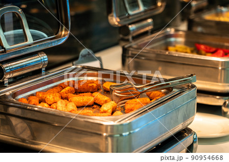 Heated buffet containers with potato sticks for breakfast in hotel restaurant 90954668